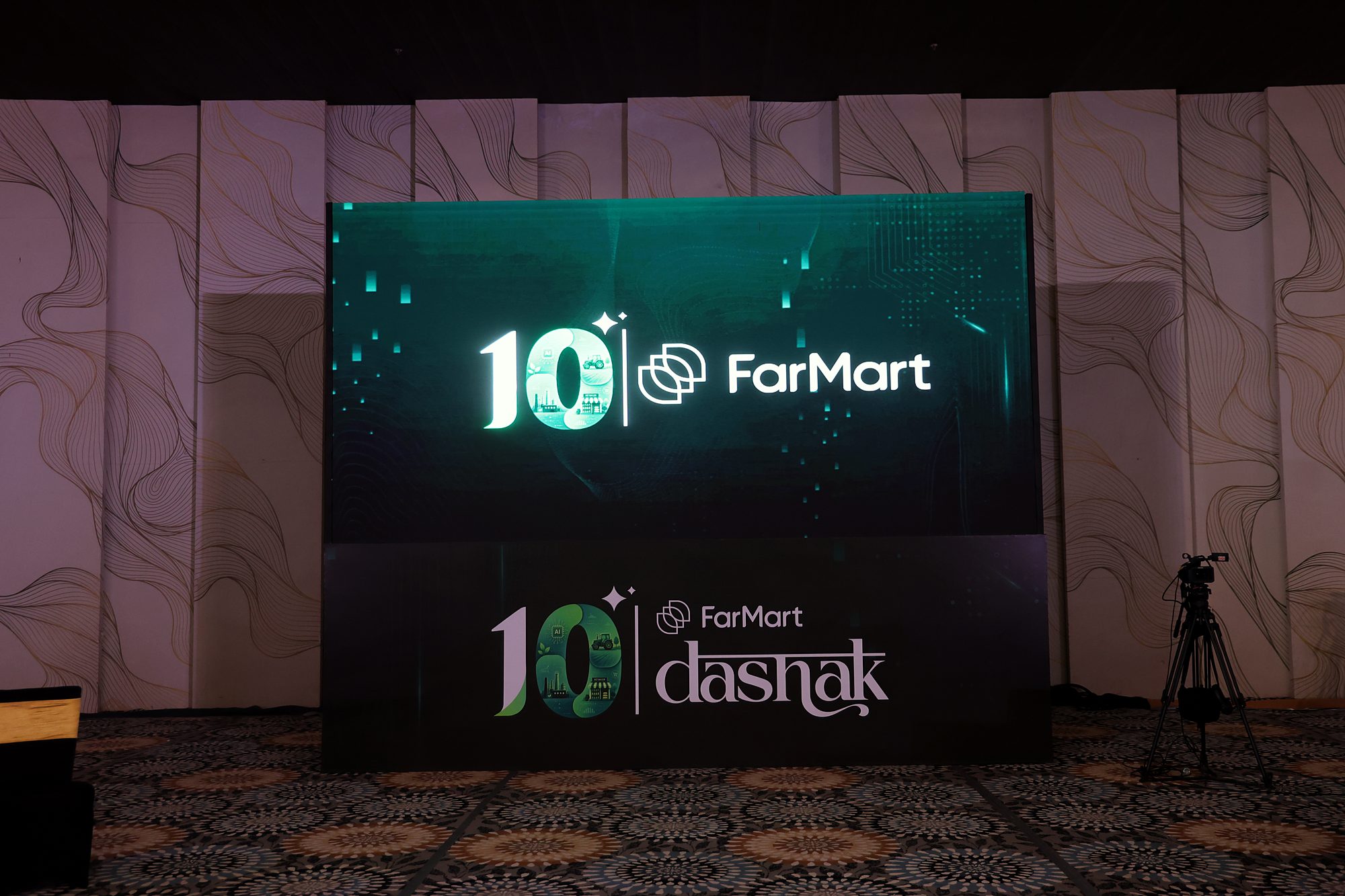 The main function stage: an LED screen showing the 10 FarMart lockup above a stage front with the full 10 FarMart dashak lockup.